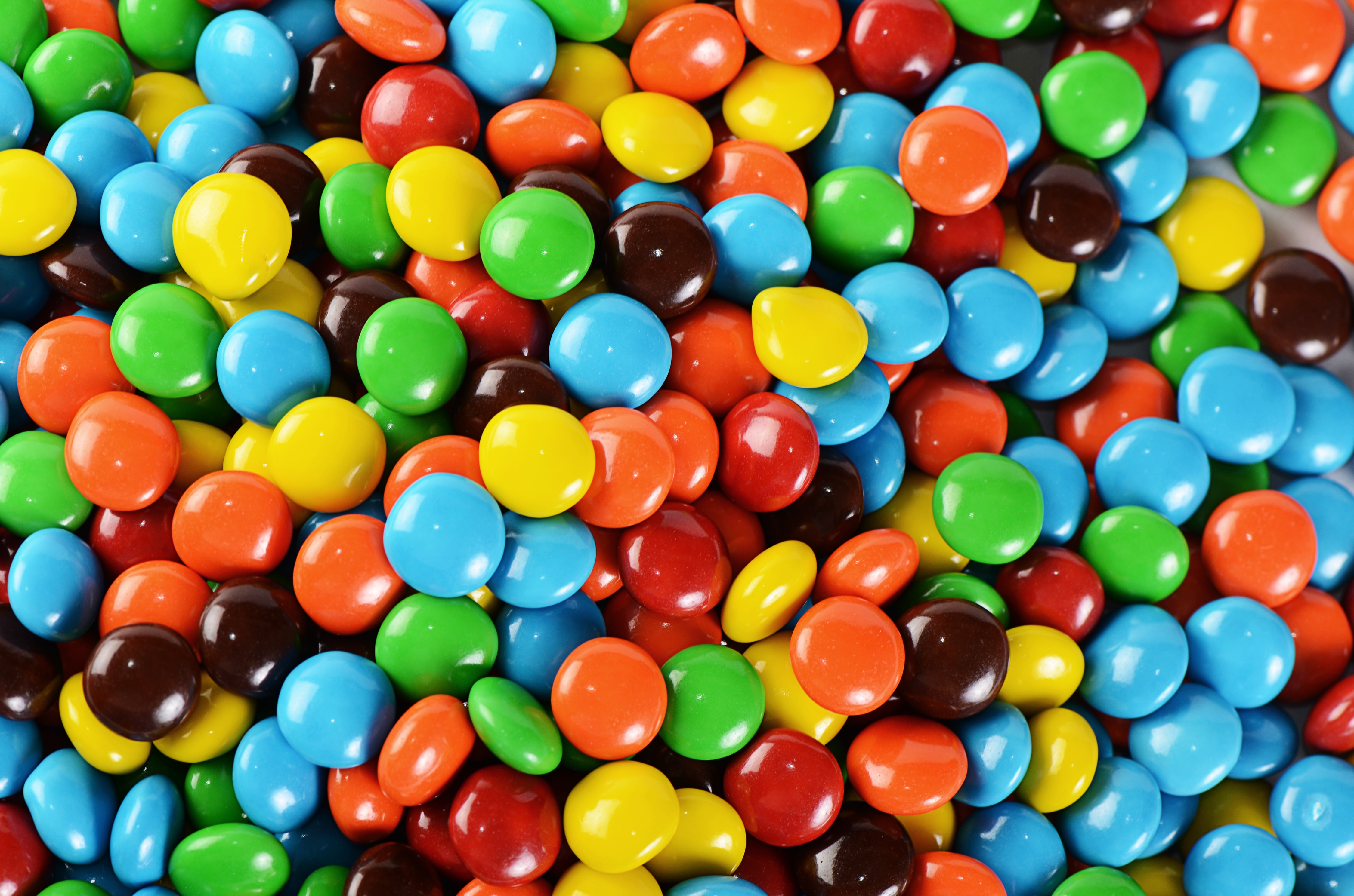Hard panned candy with acacia gum coating