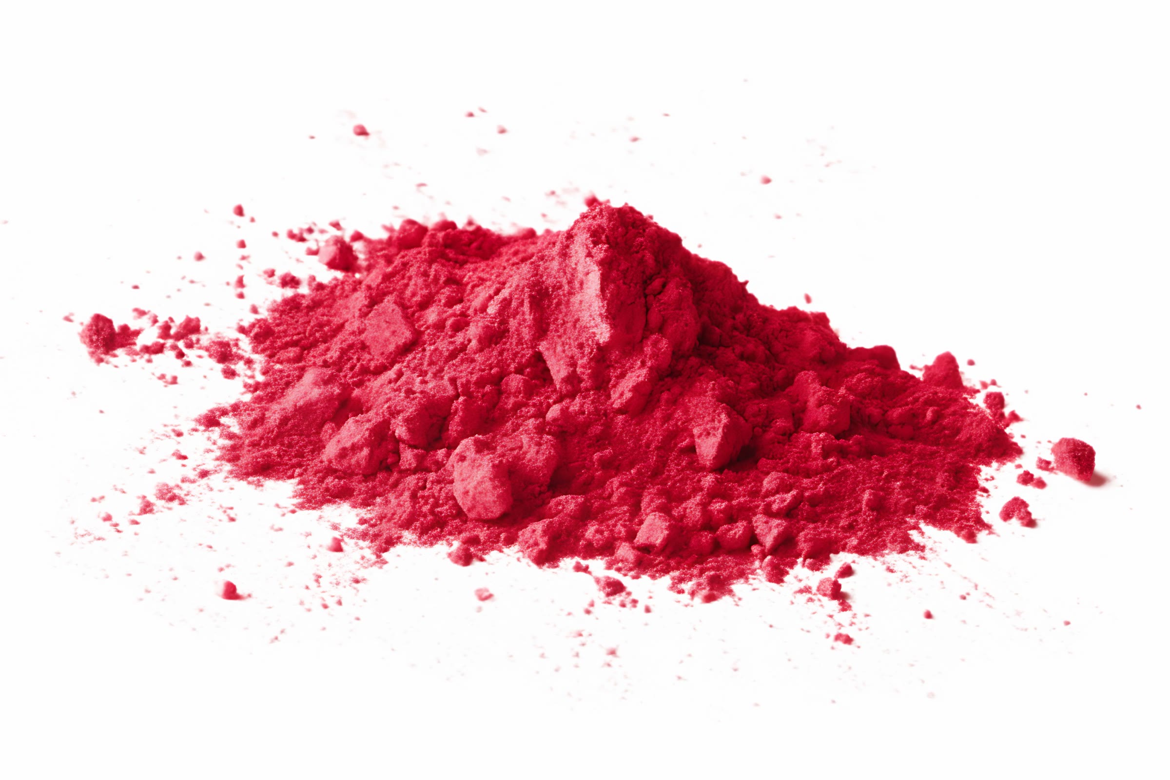A heap of crimson red powder on a white surface